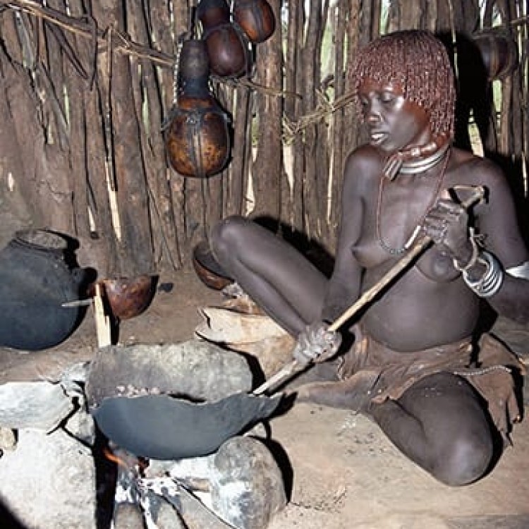 Chase | Ethiopia - 156-19 Preparing meal inside hut