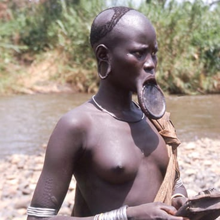 Chase | Ethiopia - 161-03s Mursi playing handmade musical instrument